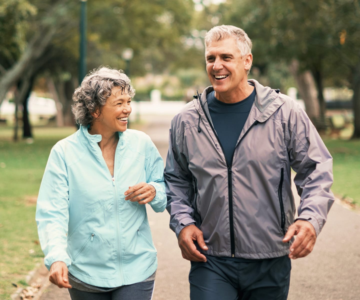 Man and woman smiling while jogging